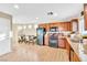 Bright kitchen features laminate floors, black appliances, and adjacent dining area at 4195 Story Rock St, Las Vegas, NV 89115