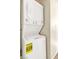 Efficient laundry room features a white stackable washer and dryer at 4195 Story Rock St, Las Vegas, NV 89115