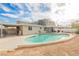 Large backyard with a pool, covered patio, and desert landscaping at 4666 Plata Del Sol Dr, Las Vegas, NV 89121