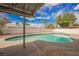 Backyard swimming pool with a covered patio, desert landscaping and privacy fence at 4666 Plata Del Sol Dr, Las Vegas, NV 89121
