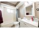 Bathroom with tiled shower-tub, toilet, vanity, mirror and neutral color palette at 4666 Plata Del Sol Dr, Las Vegas, NV 89121