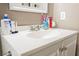 Close-up view of the bathroom vanity with white countertop and storage cabinet at 4666 Plata Del Sol Dr, Las Vegas, NV 89121