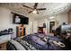 Cozy bedroom featuring a ceiling fan with lights and a television at 4666 Plata Del Sol Dr, Las Vegas, NV 89121