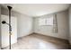 A minimalist bedroom with neutral walls, hardwood floors, and a bright window at 4666 Plata Del Sol Dr, Las Vegas, NV 89121