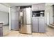 This kitchen features gray cabinets, a stainless steel refrigerator, and wood-look floors at 4666 Plata Del Sol Dr, Las Vegas, NV 89121