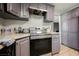 The kitchen features stainless steel appliances, gray cabinets, and wood-look floors at 4666 Plata Del Sol Dr, Las Vegas, NV 89121