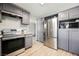 The kitchen features gray cabinets, stainless steel appliances, and wood-look floors at 4666 Plata Del Sol Dr, Las Vegas, NV 89121