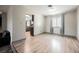 Open living area featuring bright floors, neutral paint, window with curtains, and a partial view of kitchen at 4666 Plata Del Sol Dr, Las Vegas, NV 89121