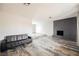 Open-concept living room with a decorative fireplace at 4666 Plata Del Sol Dr, Las Vegas, NV 89121