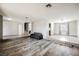 Open-concept living room featuring hardwood floors, neutral walls, and a modern couch at 4666 Plata Del Sol Dr, Las Vegas, NV 89121
