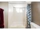 Bathtub with tiled surround, shower curtain, window, and toiletries on ledge at 4666 Plata Del Sol Dr, Las Vegas, NV 89121