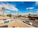 Neighborhood street view with houses, cars, desert landscaping, a palm tree and blue sky at 4666 Plata Del Sol Dr, Las Vegas, NV 89121