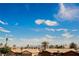 Neighborhood street view showing desert landscaping, houses, palm trees, and blue sky at 4666 Plata Del Sol Dr, Las Vegas, NV 89121