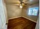 Cozy bedroom with wood floors, natural light, and a ceiling fan at 4682 Tamalpias Ave, Las Vegas, NV 89120