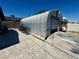 Metal garage with roll-up door, concrete pad, and exterior fan at 4682 Tamalpias Ave, Las Vegas, NV 89120