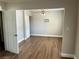 An open-concept living room with wood-look flooring and a ceiling fan at 4682 Tamalpias Ave, Las Vegas, NV 89120