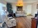 Inviting living room with a gray sofa, recliner and wood-look floors at 4682 Tamalpias Ave, Las Vegas, NV 89120