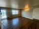 Bright living room with wood floors and sliding glass door to the backyard at 4682 Tamalpias Ave, Las Vegas, NV 89120
