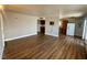 Open-concept living room with wood flooring, adjacent to kitchen and dining areas at 4682 Tamalpias Ave, Las Vegas, NV 89120