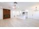 Open living room and kitchen featuring an electric fireplace, ceiling fan and white cabinetry at 508 S Jones Blvd, Las Vegas, NV 89107