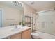 Well-lit bathroom features a single sink vanity, large mirror, and shower-tub combo at 55 E Agate Ave # 202, Las Vegas, NV 89123