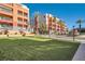 Exterior view of the multi-story condos with lawn at 55 E Agate Ave # 202, Las Vegas, NV 89123