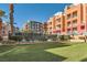 Exterior view of the multi-story condos and tennis court at 55 E Agate Ave # 202, Las Vegas, NV 89123