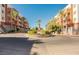 Community entrance with palm trees and manicured landscaping at 55 E Agate Ave # 202, Las Vegas, NV 89123