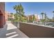 Comfortable patio with views of neighborhood buildings and mature trees at 55 E Agate Ave # 202, Las Vegas, NV 89123