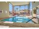 Inviting indoor swimming pool bathed in natural light from expansive windows at 55 E Agate Ave # 202, Las Vegas, NV 89123