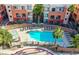 View from above of a community pool surrounded by apartments and palm trees at 55 E Agate Ave # 202, Las Vegas, NV 89123