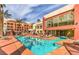 Resort style pool with lounge chairs and palm trees in a community setting at 55 E Agate Ave # 202, Las Vegas, NV 89123