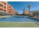 Community tennis court with benches, landscaping and view of condos on a sunny day at 55 E Agate Ave # 202, Las Vegas, NV 89123