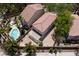 Aerial view of a home with a tile roof, a backyard pool, and a brick patio at 5516 Ness Ave, Las Vegas, NV 89118
