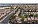 Expansive aerial view of a well-maintained community featuring tree-lined streets and uniform homes with terracotta roofs at 5516 Ness Ave, Las Vegas, NV 89118