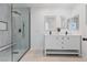Modern bathroom featuring a double sink vanity and glass enclosed shower with marble tile at 5516 Ness Ave, Las Vegas, NV 89118