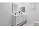 Bathroom features dual sinks, framed LED mirrors, and neutral colors at 5516 Ness Ave, Las Vegas, NV 89118