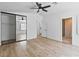 Spacious bedroom features a ceiling fan, mirrored closet, and access to bathroom at 5516 Ness Ave, Las Vegas, NV 89118