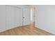 Bright bedroom featuring wood flooring and a closet with white sliding doors at 5516 Ness Ave, Las Vegas, NV 89118