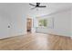 Bright bedroom features a ceiling fan, shuttered windows, and a door to the bathroom at 5516 Ness Ave, Las Vegas, NV 89118