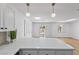 Kitchen with white cabinets, bar seating, and sliding doors leading to the backyard at 5516 Ness Ave, Las Vegas, NV 89118