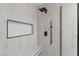 Modern shower with black fixtures, bench, and a built in shelf at 5516 Ness Ave, Las Vegas, NV 89118