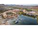 Picturesque Lake Las Vegas aerial view with marina, waterfront buildings, and scenic mountain backdrop on a sunny day at 58 Sun Lily Ln, Henderson, NV 89011