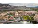 Aerial view of Lake Las Vegas showcasing colorful buildings, a swimming pool, and lush landscaping along the waterfront at 58 Sun Lily Ln, Henderson, NV 89011
