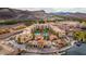 Aerial view of Lake Las Vegas shows waterfront buildings, swimming pools, and lush landscaping near the waterfront at 58 Sun Lily Ln, Henderson, NV 89011