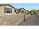 Desert-landscaped backyard with a view of the home's exterior at 58 Sun Lily Ln, Henderson, NV 89011