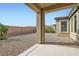Backyard view featuring desert landscaping and a covered patio at 58 Sun Lily Ln, Henderson, NV 89011