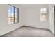 Carpeted bedroom with a closet and natural light coming from two windows offering views of the neighborhood at 58 Sun Lily Ln, Henderson, NV 89011