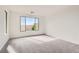 Spacious bedroom features neutral carpet, large window providing natural light, creating a calm ambiance at 58 Sun Lily Ln, Henderson, NV 89011
