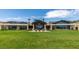 Expansive backyard with lush lawn, contemporary home design, and outdoor seating area at 58 Sun Lily Ln, Henderson, NV 89011